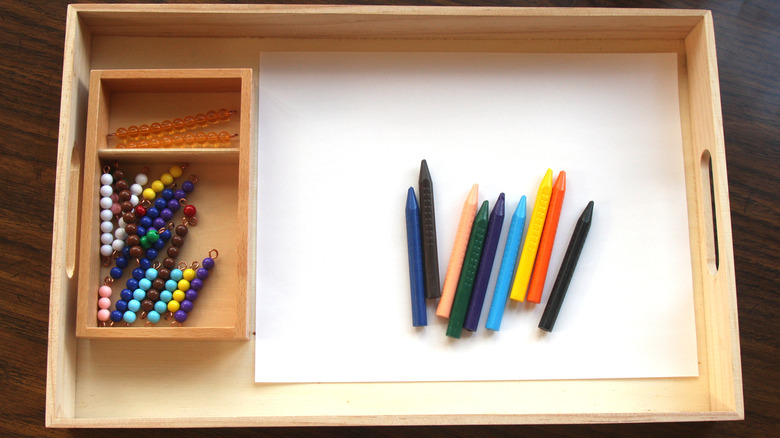 tray containing beads and crayons