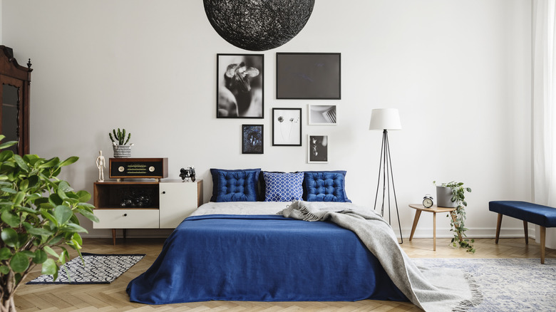 Blue bedding in white room