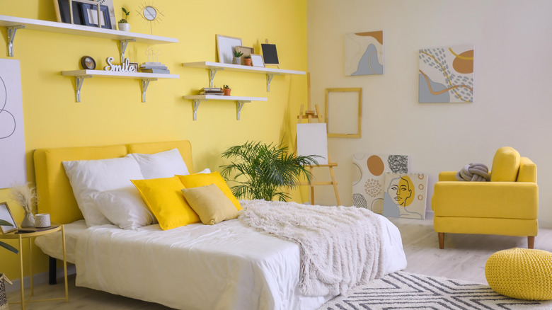 Yellow bedroom with white bedding