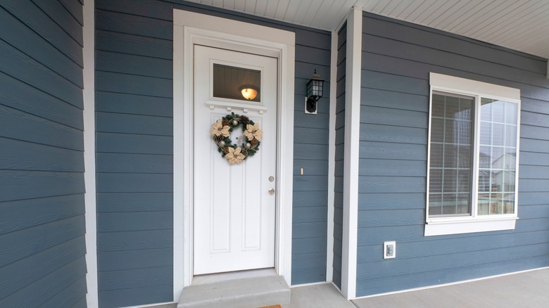 White door on blue house