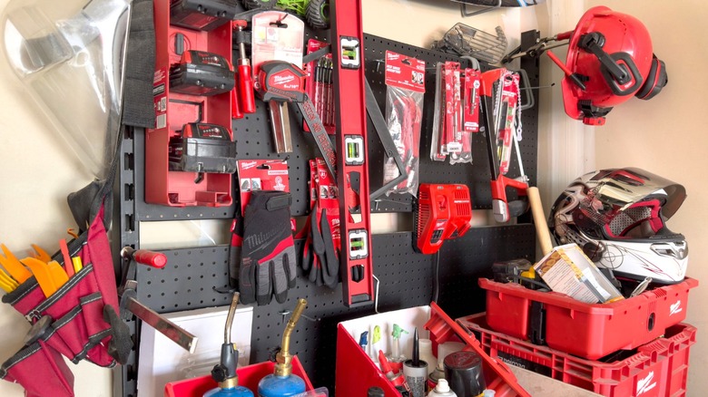 Collection of Milwaukee tools on a garage pegboard