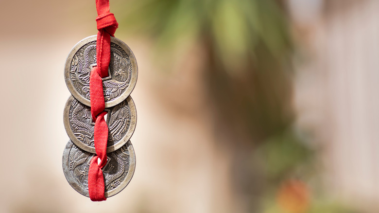 Chinese coins on red ribbon