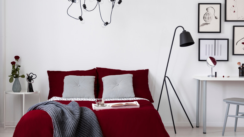 red-covered bed with black accents