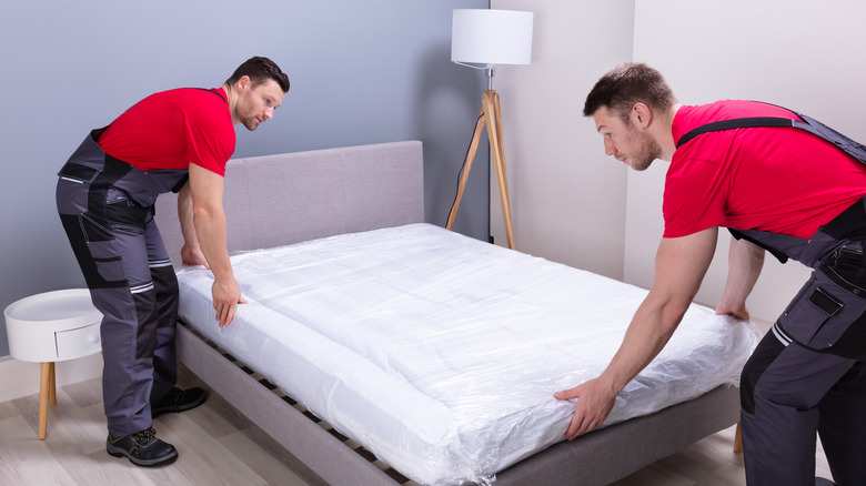 Two men moving mattress