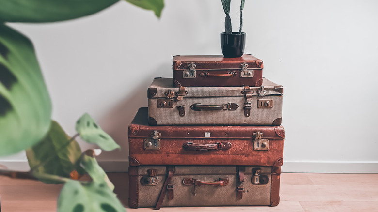 Old suitcases stacked in room