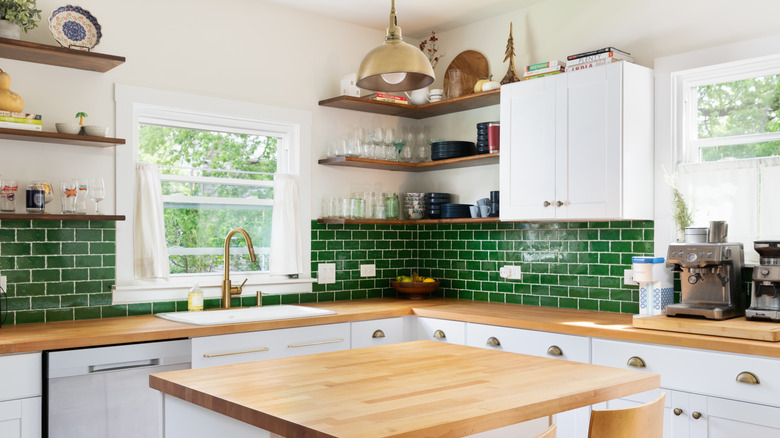 white kitchen with green tiles