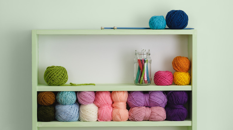 Green shelf with yarn