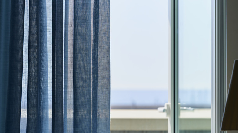 Blue curtain against glass door