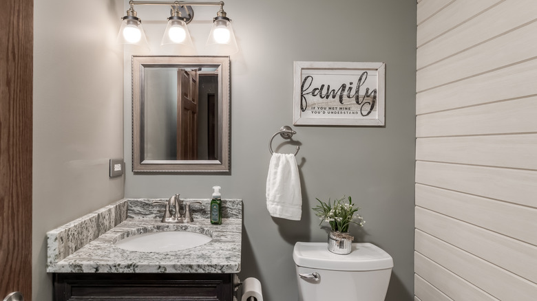 Half bathroom with wall decoration