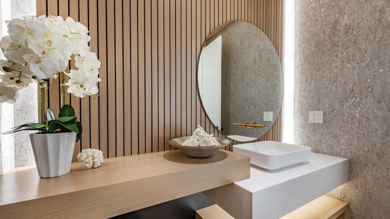 Bathroom with stone and wood slat walls