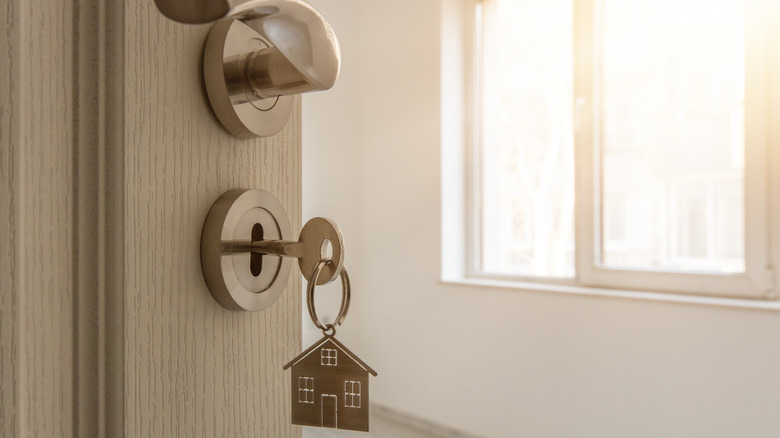 Home keychain hanging in door