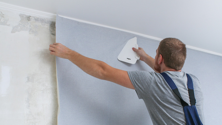 installing wallpaper on a wall