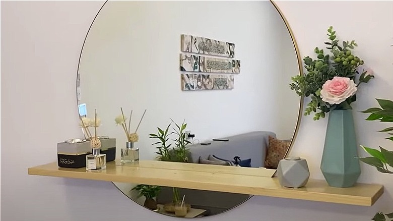 Floating shelf on round mirror