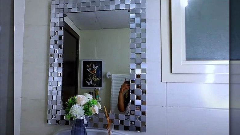 Mosaic tiles around mirror