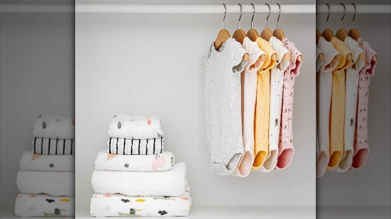 hanging and folded baby clothes