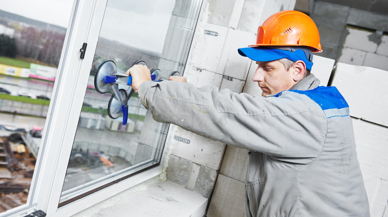 construction worker installing window