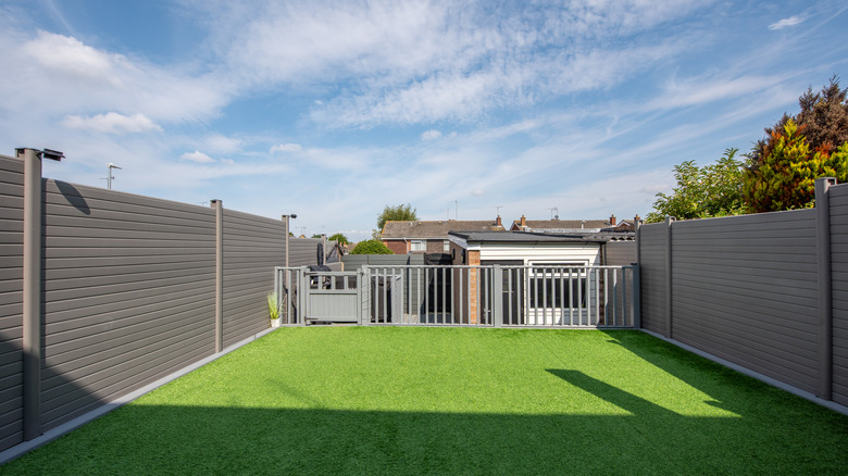 Vinyl fence posts surrounding backyard