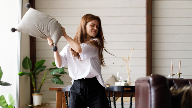 woman holding pillow high