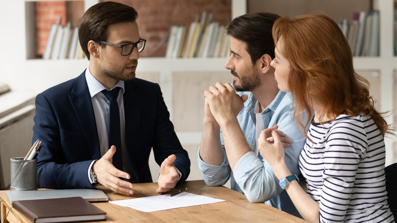 Couple talking with an agent