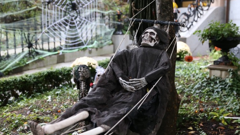 Skeleton in hammock with web