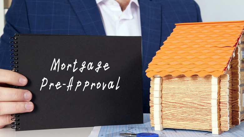 man holding mortgage preapproval sign