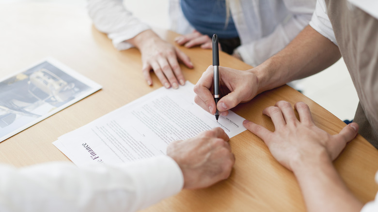 person signing a contract