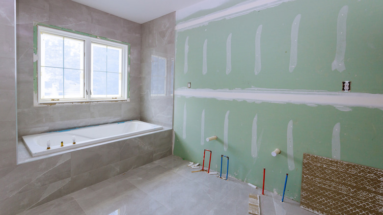 unfinished remodeled bathroom with bare wall