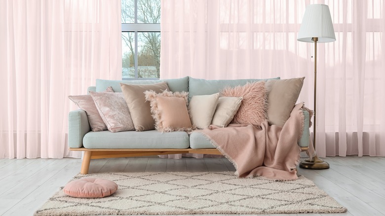 Gray sofa with pink pillows