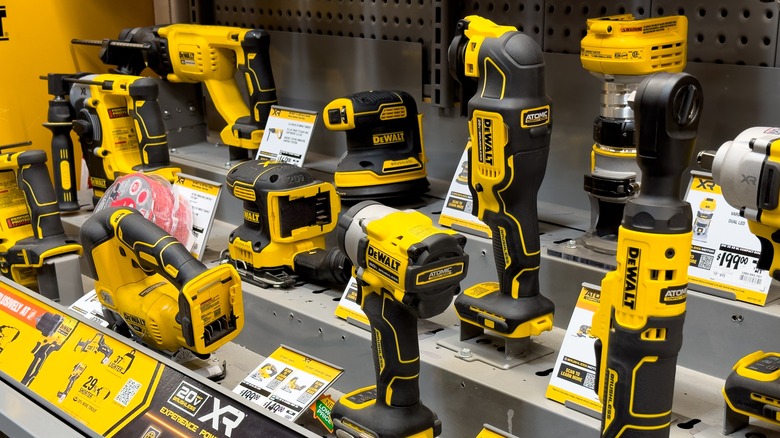 Assorted DeWalt power hand tools are on a shelf display