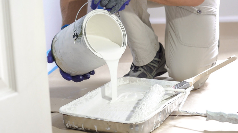 pouring paint into tray