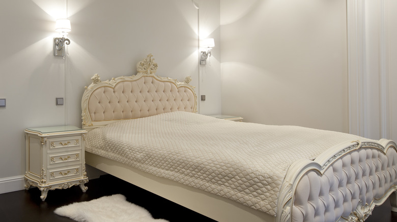 Luxurious bed with wall sconces