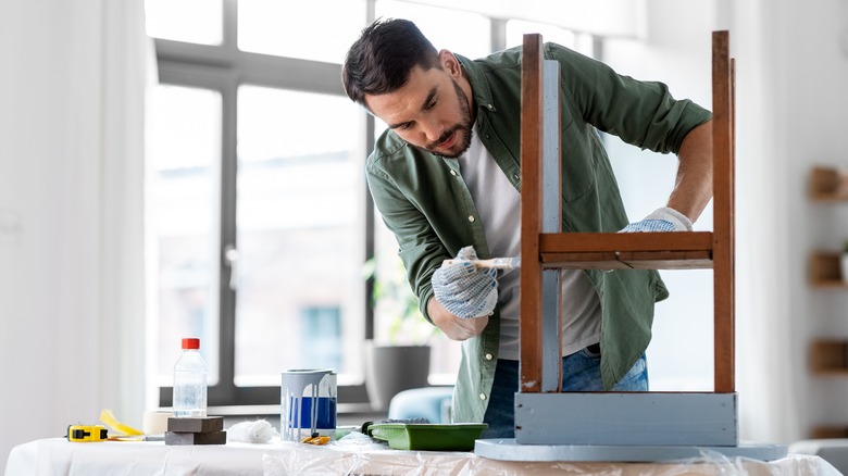 Person painting furniture