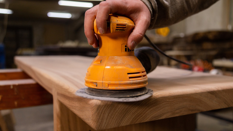 Person sanding furniture