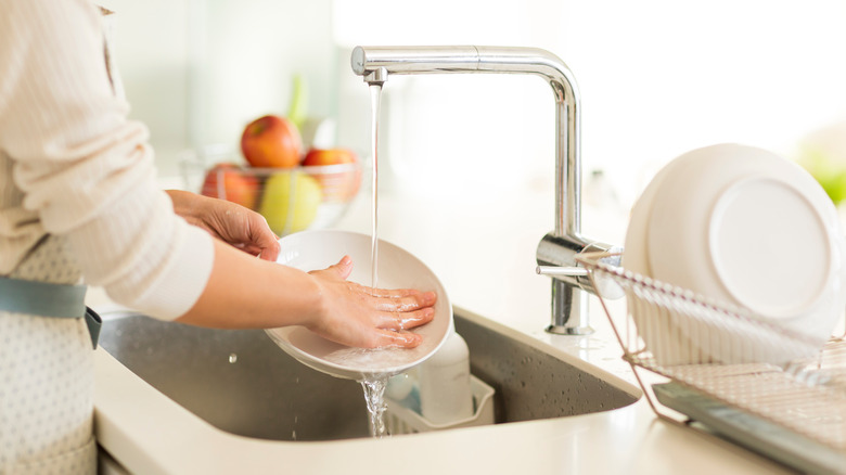 Washing dishes with bare hands