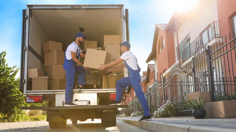 Professional movers loading boxes