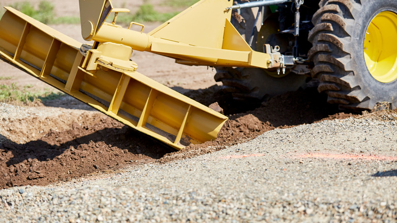 Tractor grading a gravel driveway