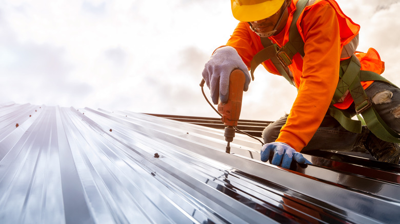 man installing roof