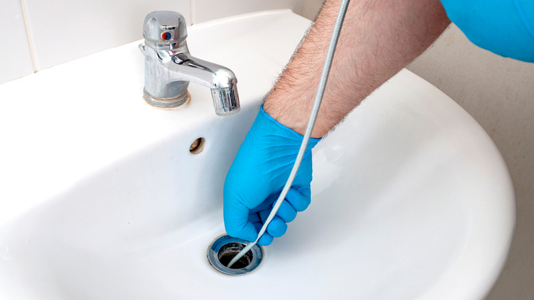 Using a plumber's snake on a sink drain