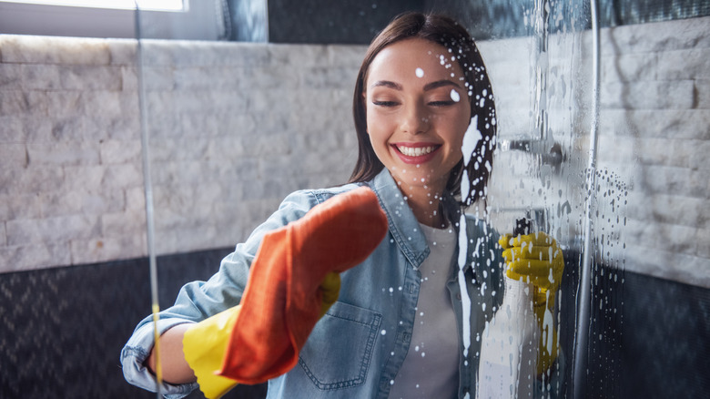 A woman wiping the shower door