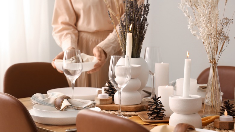 A woman sets a dining room table