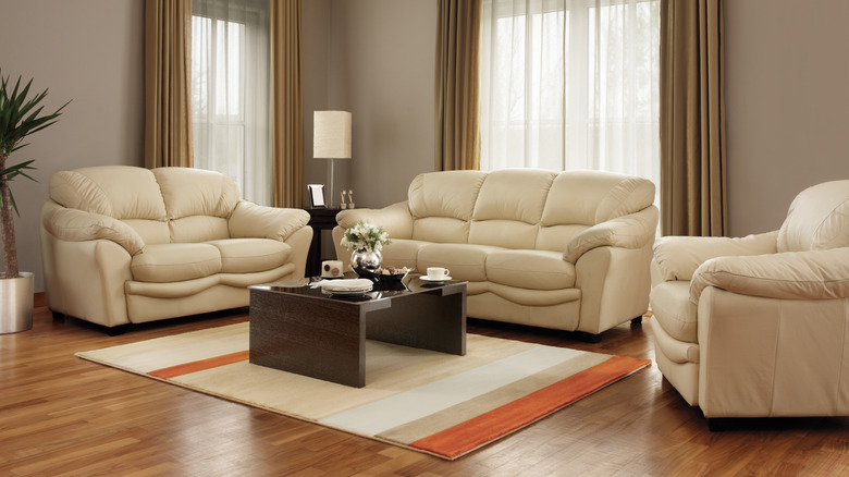 Living room with beige matching couch, loveseat, and chair