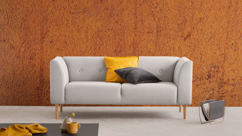 Beige couch against orange wall