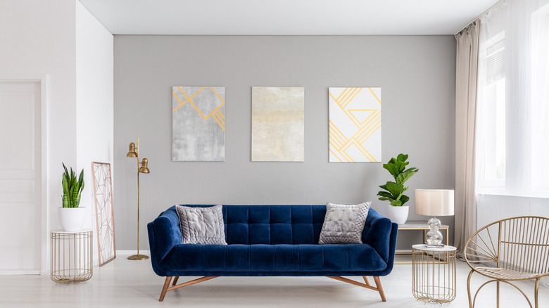 Blue couch in a gray room