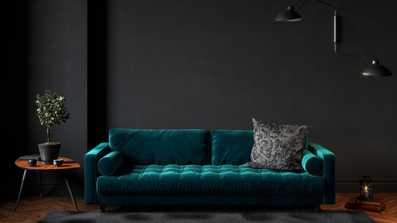 Deep-green sofa with black wall