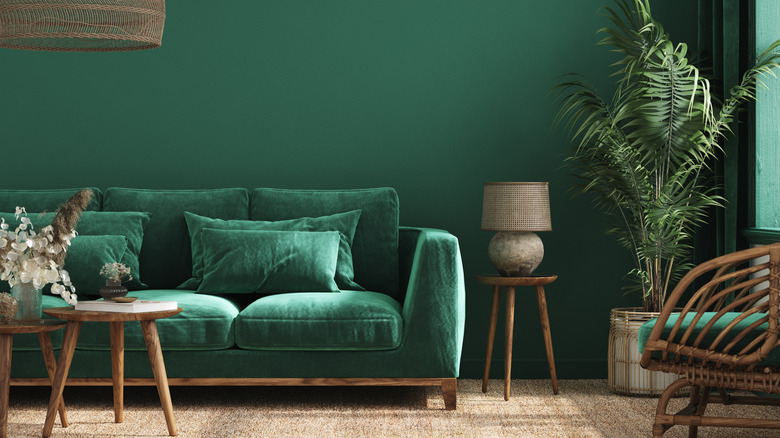 Green couch against green wall