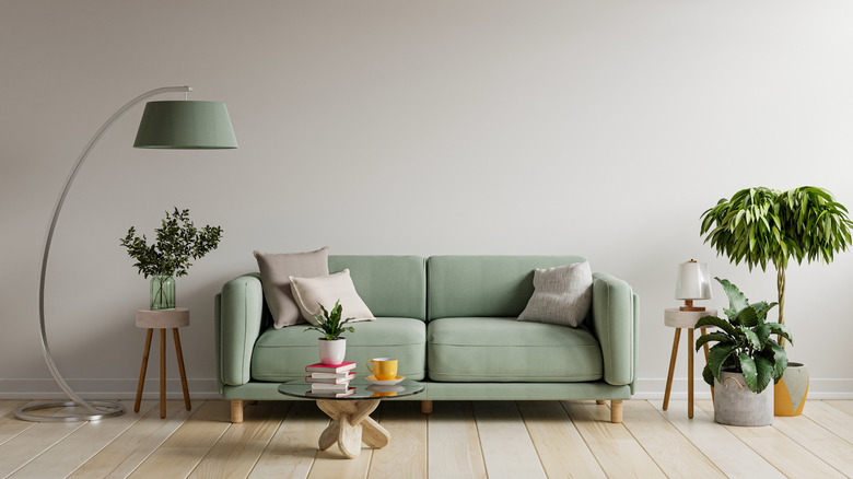 Green couch against tan wall