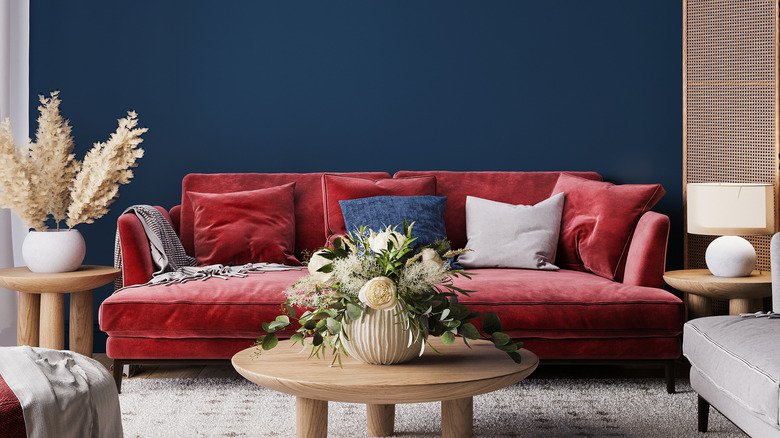 Navy blue room with red couch