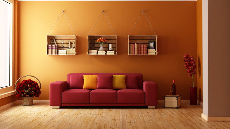 Red couch with tangerine walls