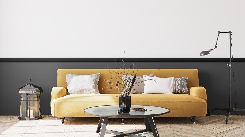 Yellow sofa on gray wall