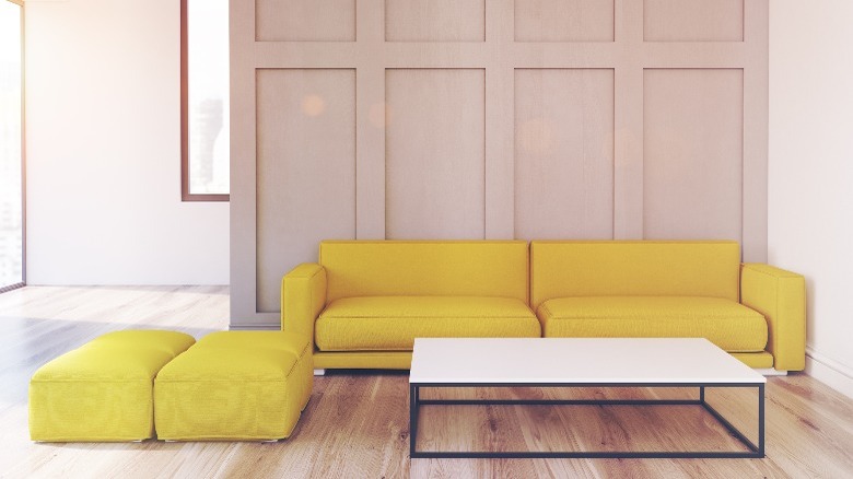 Yellow sofa on wood wall